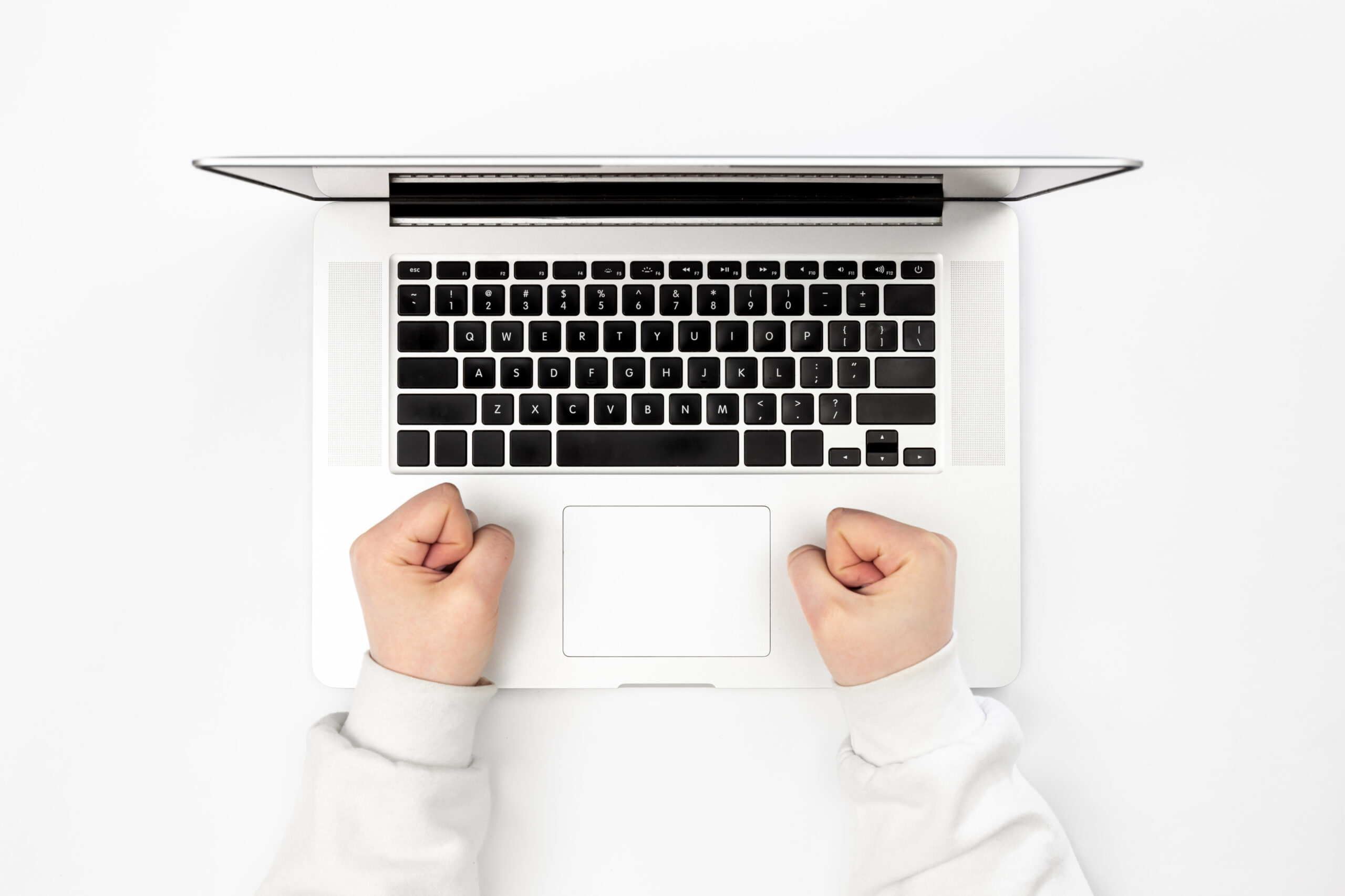 Laptop on a white background and female hands, top view. frustration